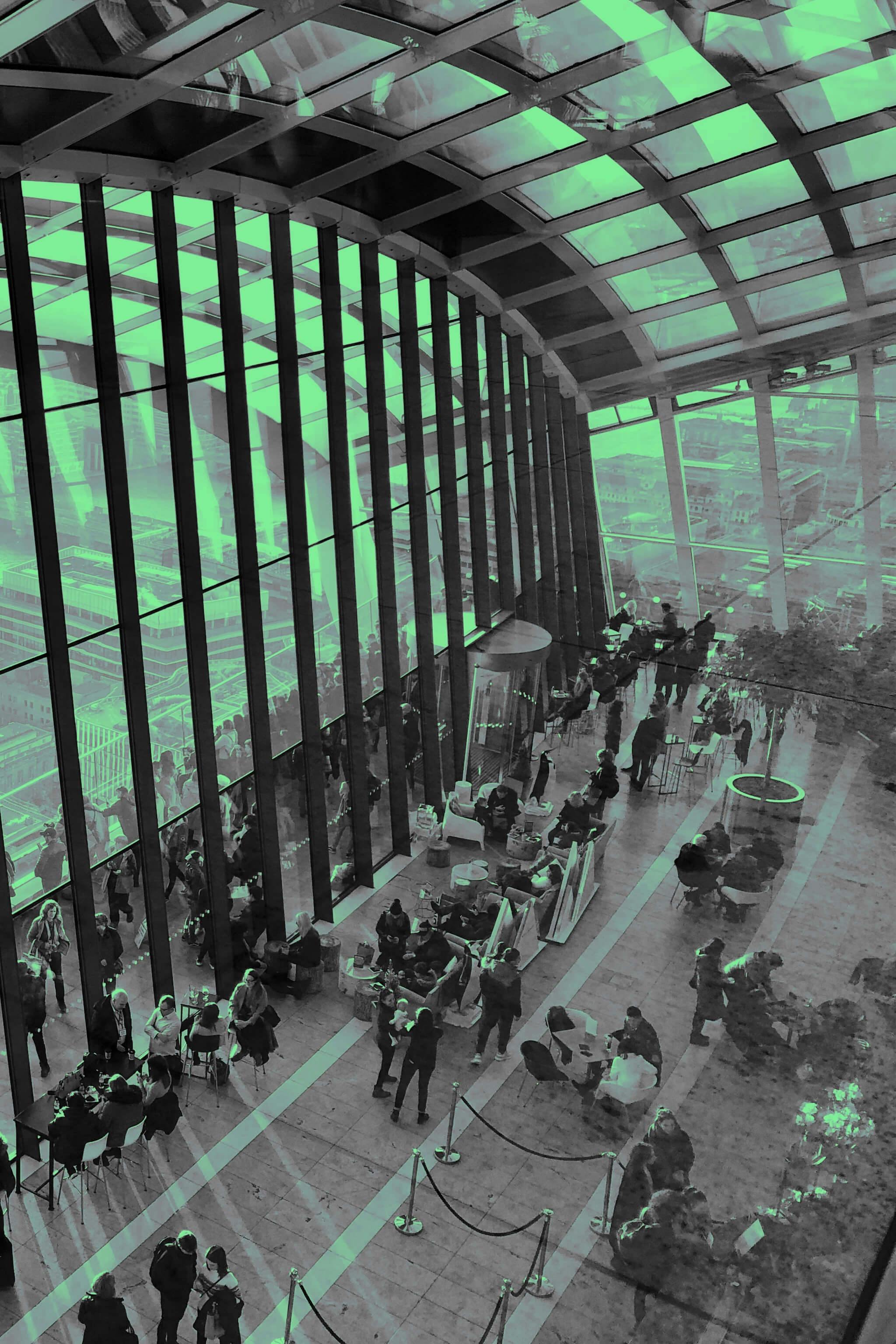 Panoramic view of people talking at the Sky Garden in London.